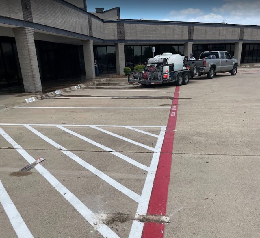 Freshly striped shopping center parking lot with the Nitty Gritty trailer rig parked by the storefronts